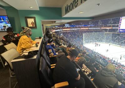 People in the stands watching a hockey game with enthusiasm