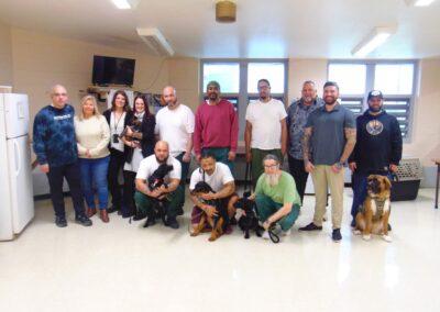 A group of people posing with dogs